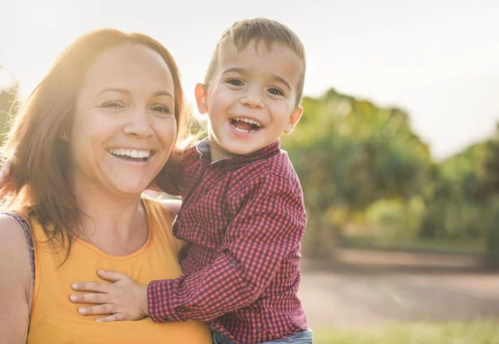 Parent laughing together with a child outdoors