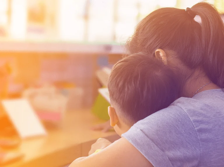 Parent embracing a child in a comforting hug