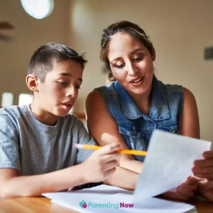 Mother helping her son with homework at the table