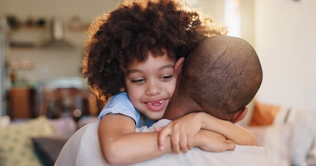 Child hugging a parent warmly at home