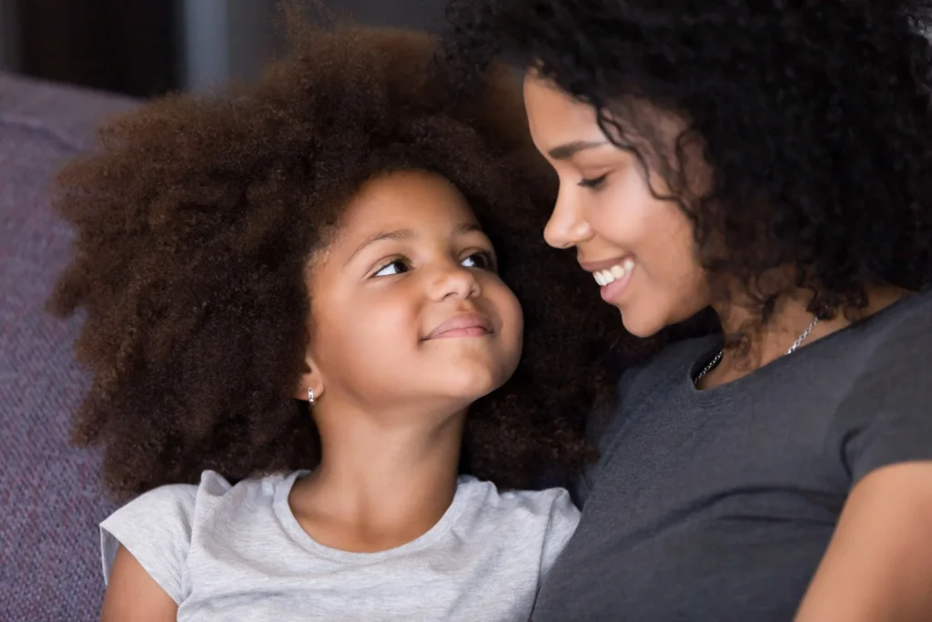 Mother and daughter sharing a close, smiling moment together