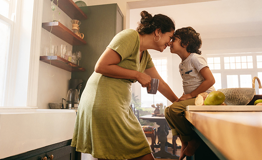 Mother and young son sharing a warm moment in the kitchen