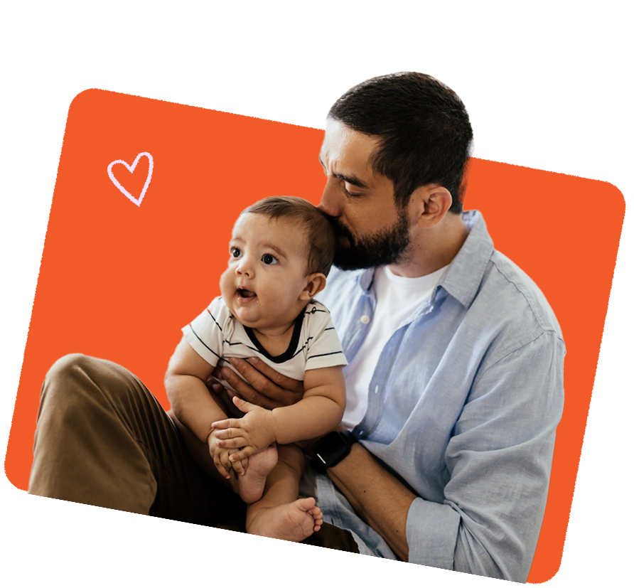 Parent gently kissing a baby's forehead