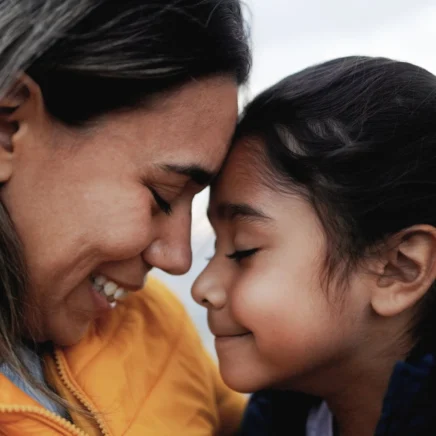 Mother embracing her daughter in a tender, comforting moment